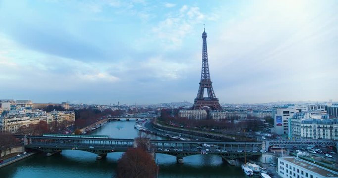 Drone shot going up of the Eiffel Tower on a cloudy day