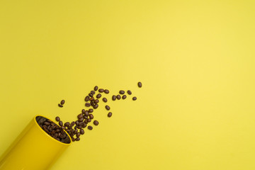 Yellow background with coffee beans and an open can in left-down corner