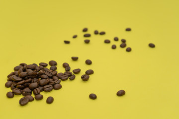 Coffee beans on yellow background