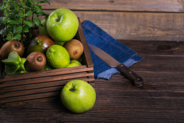 Set of green fruits for healthy diet and detox: apple, lime, kiwi, mango, carambola and mint.