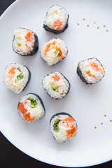 Delicious fresh sushi on a white plate, close-up.