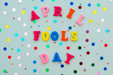 inscription April Fools Day in colorful bright wooden letters on a blue background with a holiday...