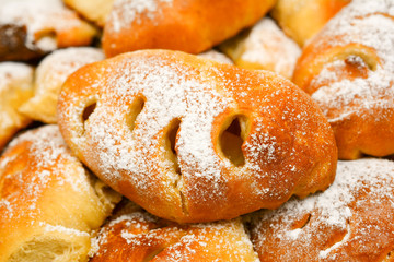 Fresh bakery, delicious, pies with powdered sugar. Cakes, small round pies containing sweet filling.