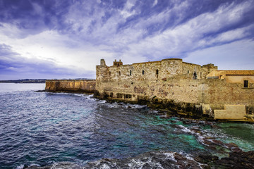 View of the castello maniace in Syracuse with dramatic sky, Sicily