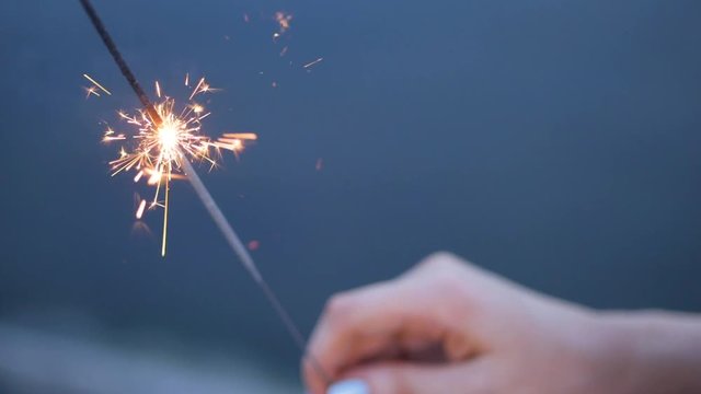 Closeup shot of female hand holding sparkler