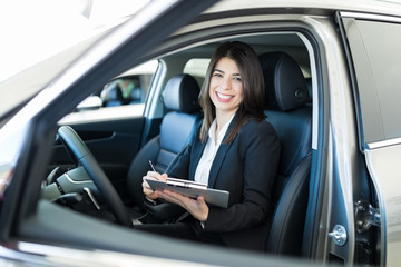 Manager Preparing Checklist In Automobile