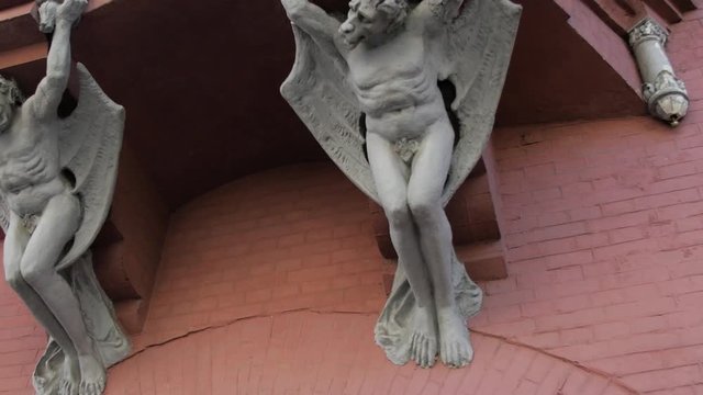 Rotating shot view of pair of chimeras on Knights castle, Kiev.