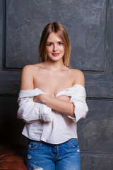 Fashion shoot of young sexy woman in blue jeans