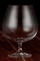 A cognac glass on a wooden table