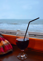 A glass of hot mulled wine on the background of the Baltic sea