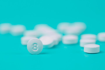 White pills or capsules on a blue background