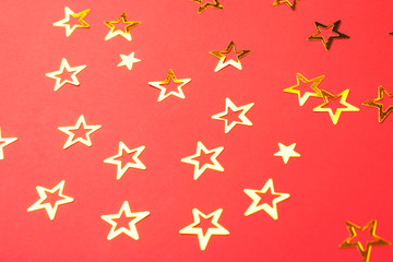 Star-shaped confetti on red background.