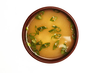 Asian soup with cod, egg and shrimps isolated on white.