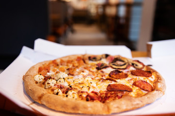 Pizza with salami, cheese and champignons
