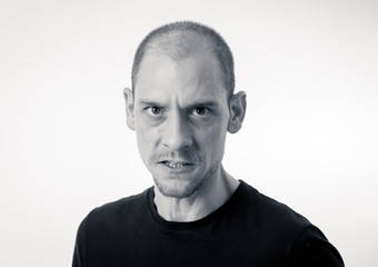 Mad and aggressive guy in facial expressions and negative human emotions