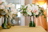 a bridal wedding bouquet in a glass jar before the wedding ceremony, White and pink flowers set down on a table