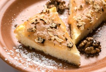 Cheesecake with cream and crushed nuts.