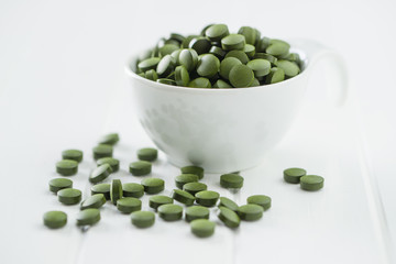 Green chlorella pills or green barley pills.