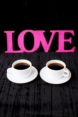 two cups of coffee on pink background inscription love Valentine's Day
