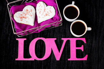 two cups of coffee, cookies in the form of heart inscription love close-up