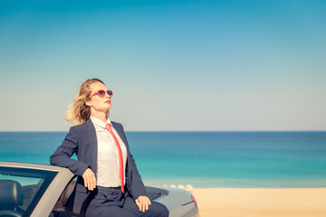 Successful young businesswoman on a beach
