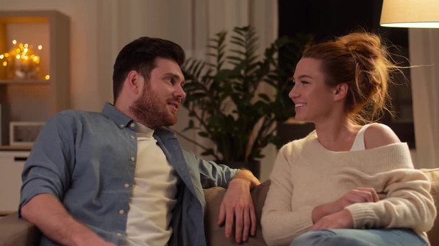 leisure and people concept - happy couple having fun at home in evening