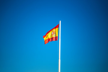 Spanish flag on the blue sky without clouds