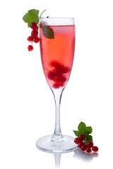 Red drink or cocktail in a glass for champagne isolated on white with red currant