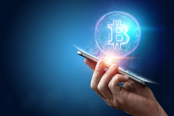 Male hand, bitcoin hologram, ultraviolet creative background. Cryptocurrency, electronic money, blockchain technology, finance, copy space.