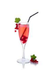 Red drink or cocktail in a glass for champagne isolated on white with red currant