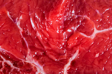 Beef raw red meat closeup texture background. Fresh beef piece in closeup. Marbled meat texture. Raw fillet of beef steak.