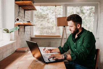 Young casual man working on a laptop