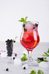 Summer cold drink with blueberry, mint lemon and ice in glass