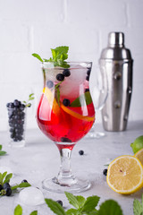Cold summer homemade fruit and berries lemonade. Mojito, lemonade or sangria in glass.