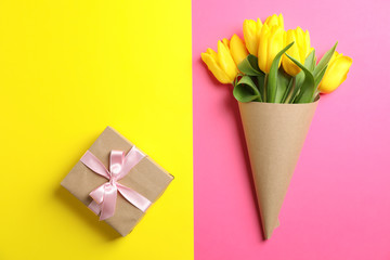 Beautiful tulips with gift for Mother's Day on light background, top view