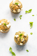 Fototapeta na wymiar Freshly baked muffins with spinach and feta cheese. Light background. Copy space.