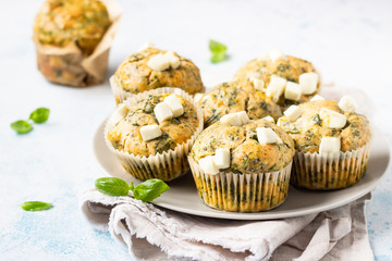 Freshly baked muffins with spinach and feta cheese. Light background. Copy space.