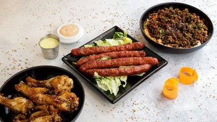 chicken wings, merguez, humous