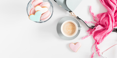 Composition Valentine's Day. Female table with handbag, pink scarf, cup of coffee, Valentine cookies on white background. Flat lay, top view, copy space