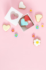 Composition Valentine's Day. Valentine cookies in shape heart on pastel pink background. Flat lay, top view, copy space