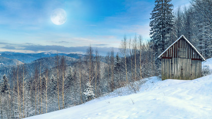 Winter landscape - view of the snowy mountain valley on moonlit evening in the Carpathians, in...