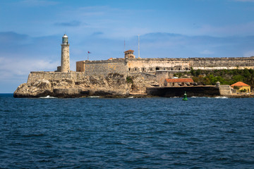Fototapeta na wymiar View over Morro Castle, fortress and a lighthouse in Havana, Cuba. Blue water and blue clear sky.