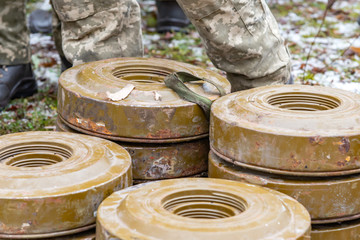 Anti-tank and anti-personnel mines without a fuse lie on the ground.