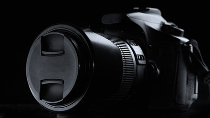 professional digital photo camera against black background