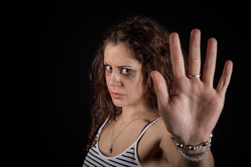 Stop violence message from a scared woman with bruises and wounds marks on her face after a case of gender violence in a young couple