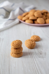 Homemade almond cookies on a white wooden table, close-up. Side view.