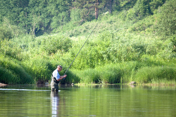 Fototapeta na wymiar Summer fishing on the lake.