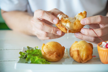 Man going to eat colourful fried ice cream ball dish - people with fast delicious unhealthy food concept