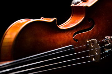 Side wooden parts retro violin on a black background