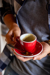 hands holding a cup of coffee